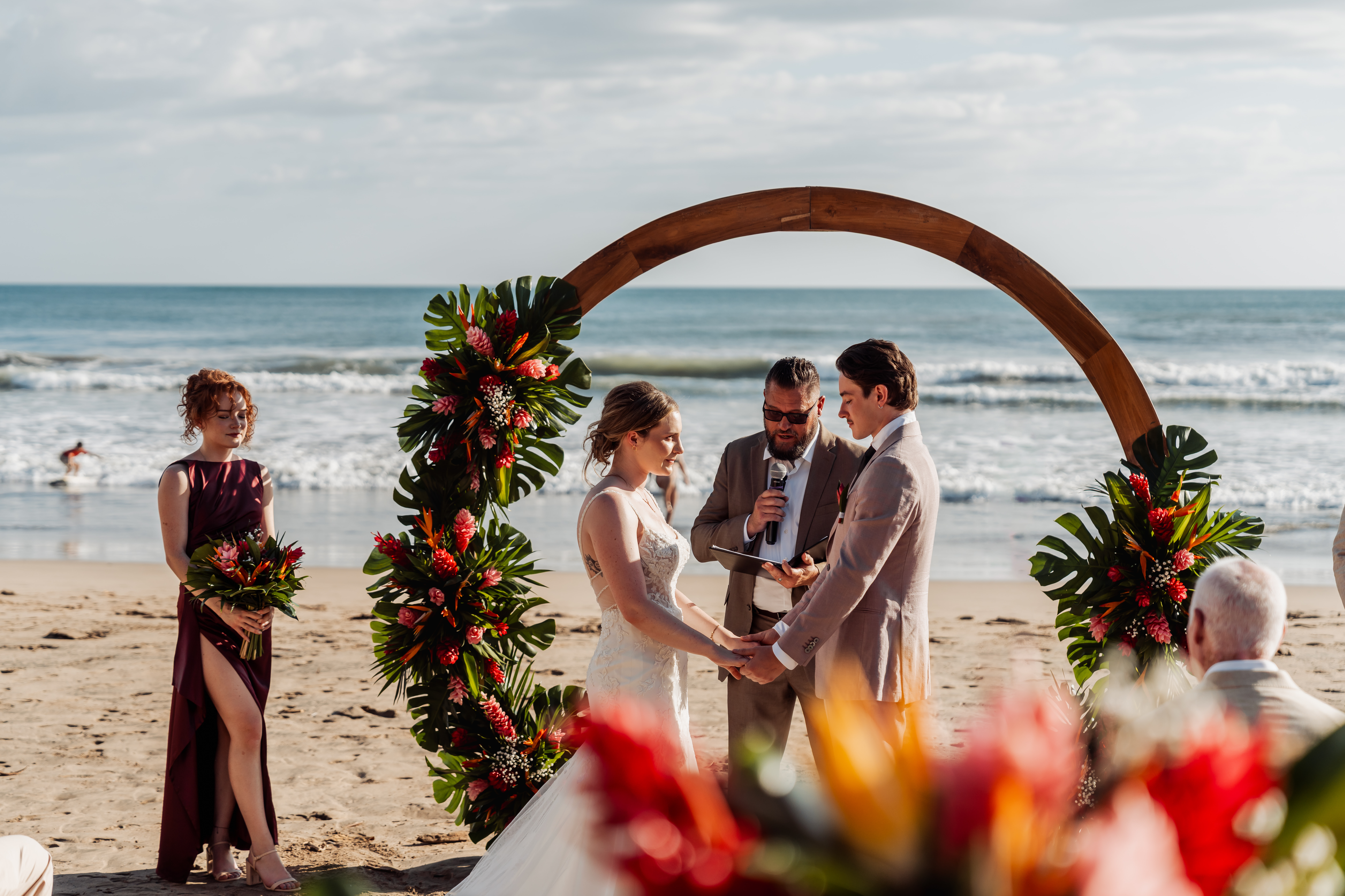 Couple exchanging vows by the ocean at ONDA Playa Grande