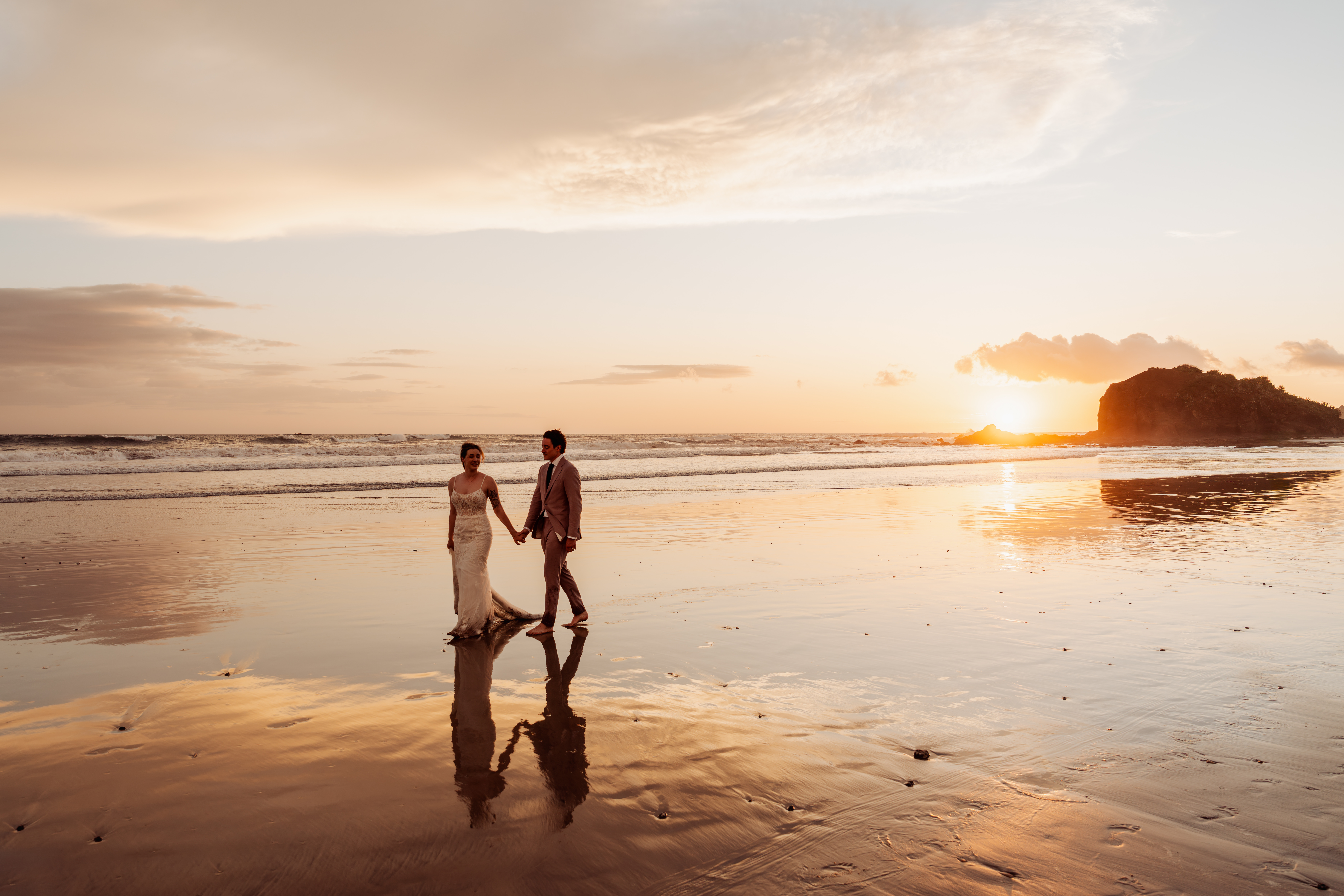 Wedding couple portraits at golden hour on the beach